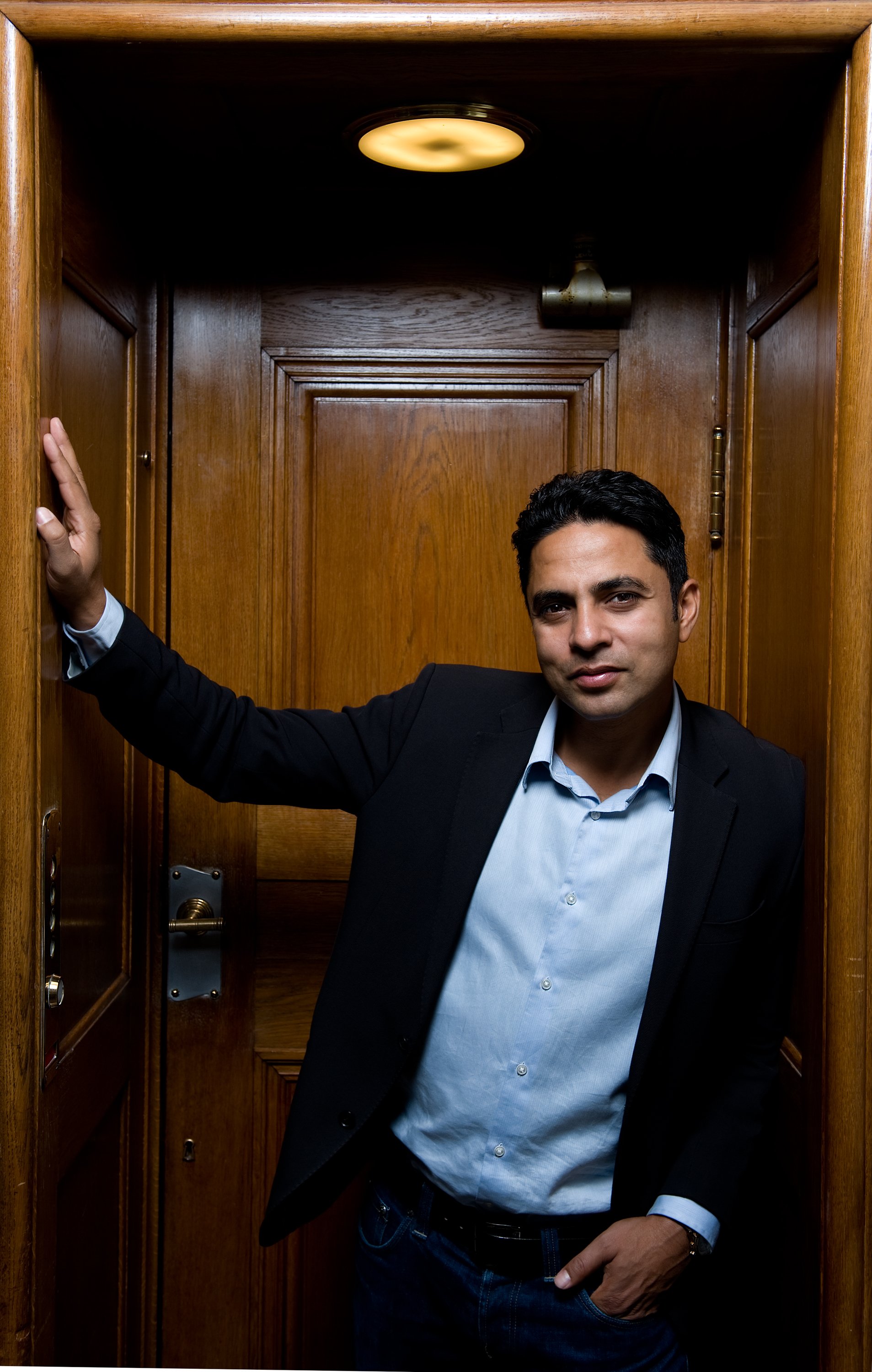 Politician Manu  Sareen calls for changes to the way in which dorm rooms are allocated. He is standing in an elevator - not to be confused with one of the aforementioned dorm rooms. 