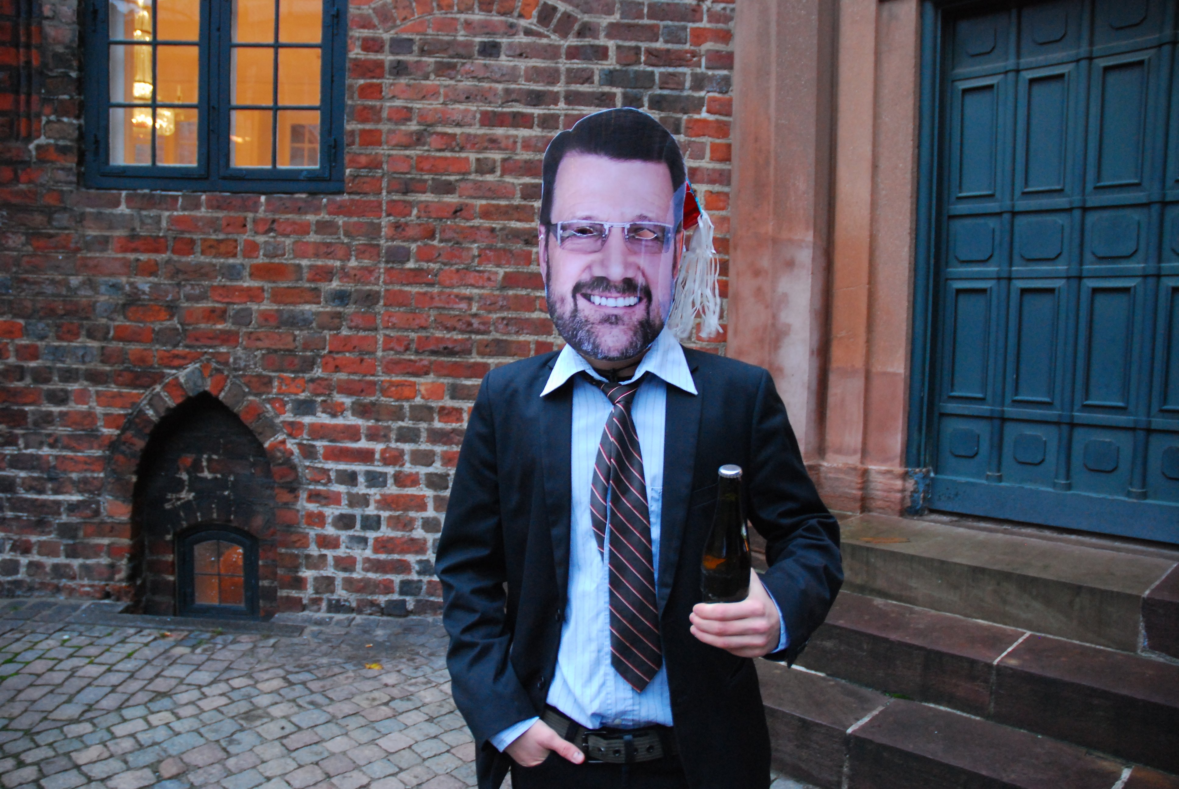 Protester with government minister Helge Sander mask at the board meeting Thursday
