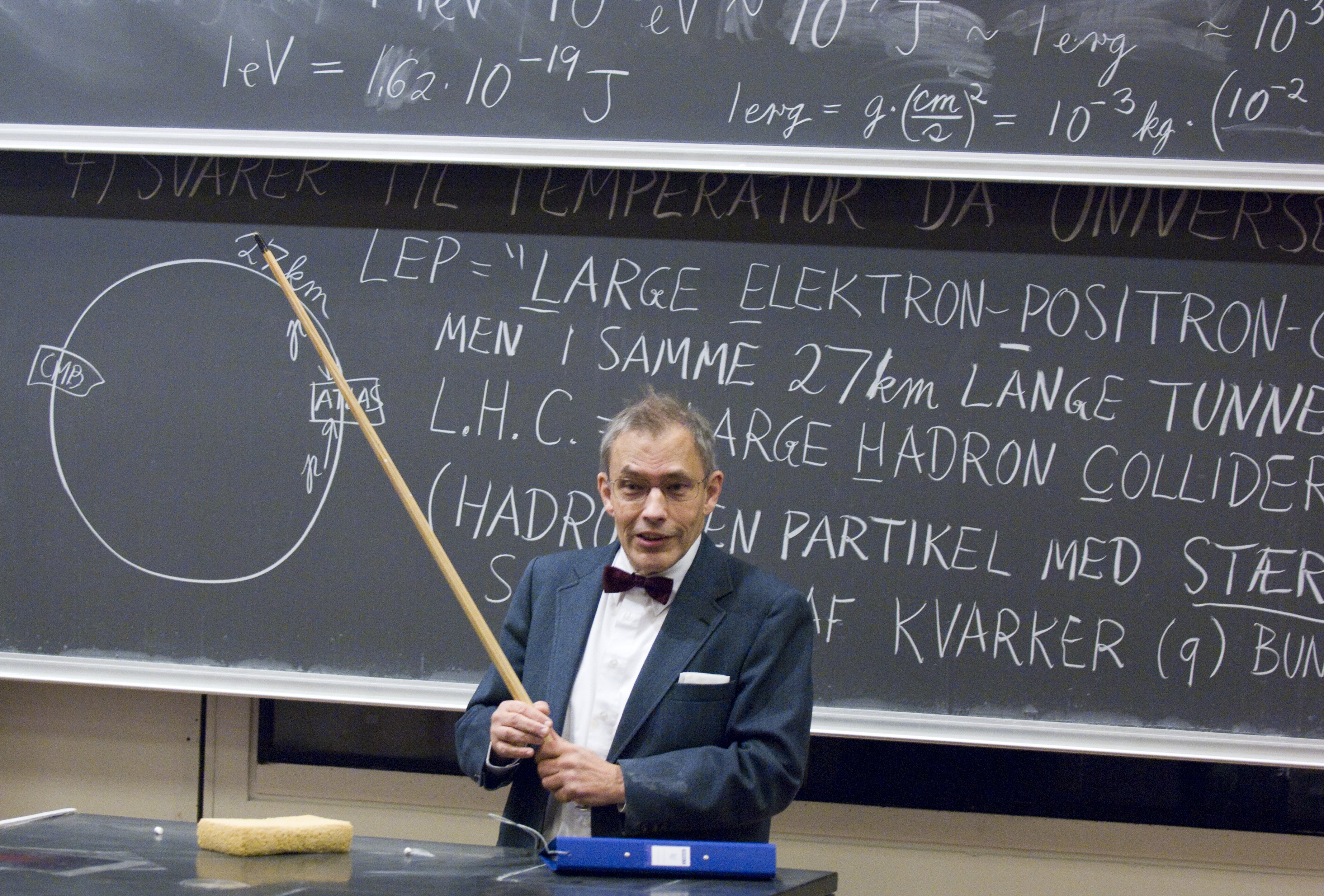 Holger Bech Nielsen and his characteristic bow tie, delivering a lecture on the Large Hadron Collider