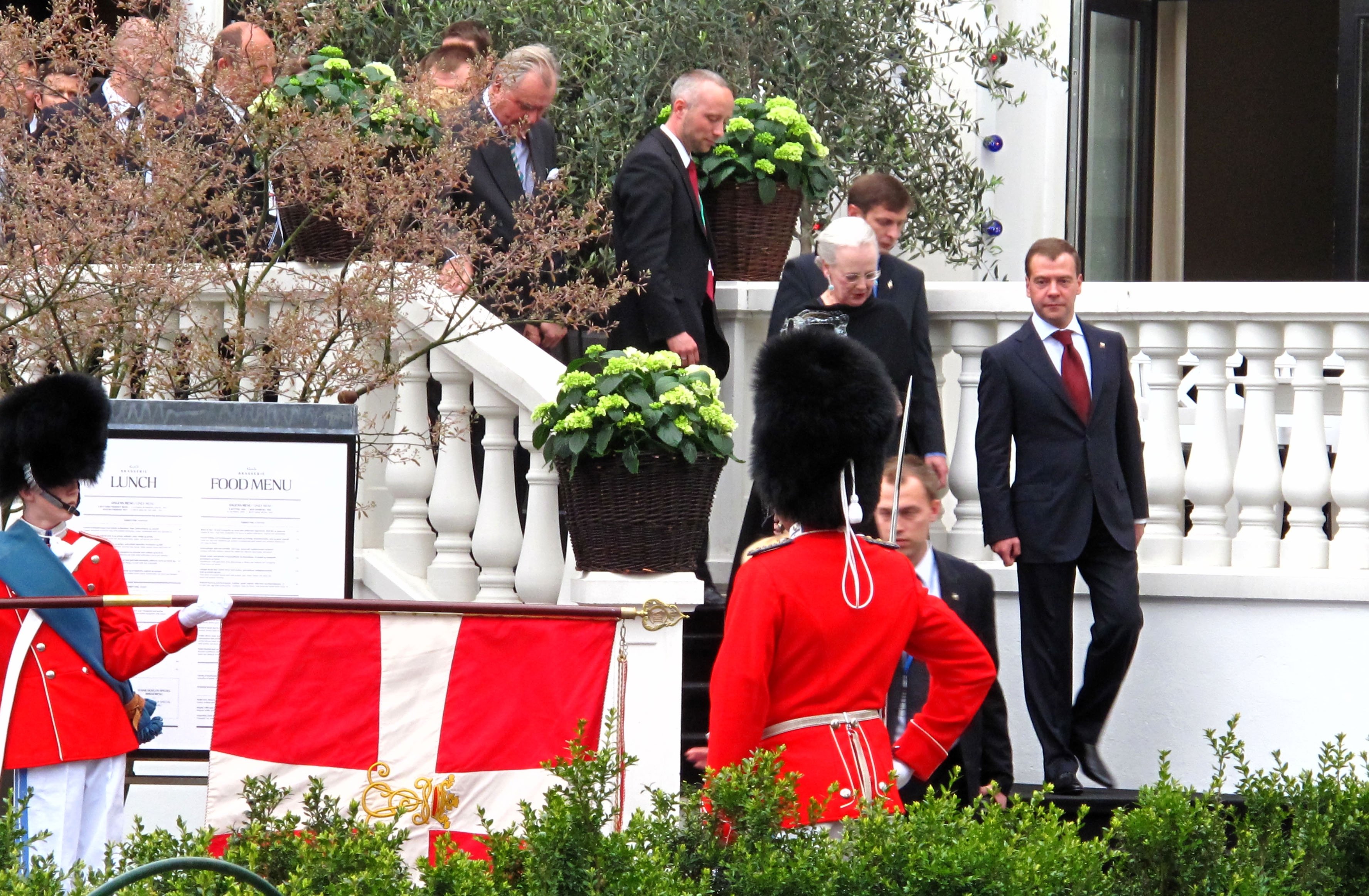 Queen Margrethe is the lady behind the soldier with the red jacket