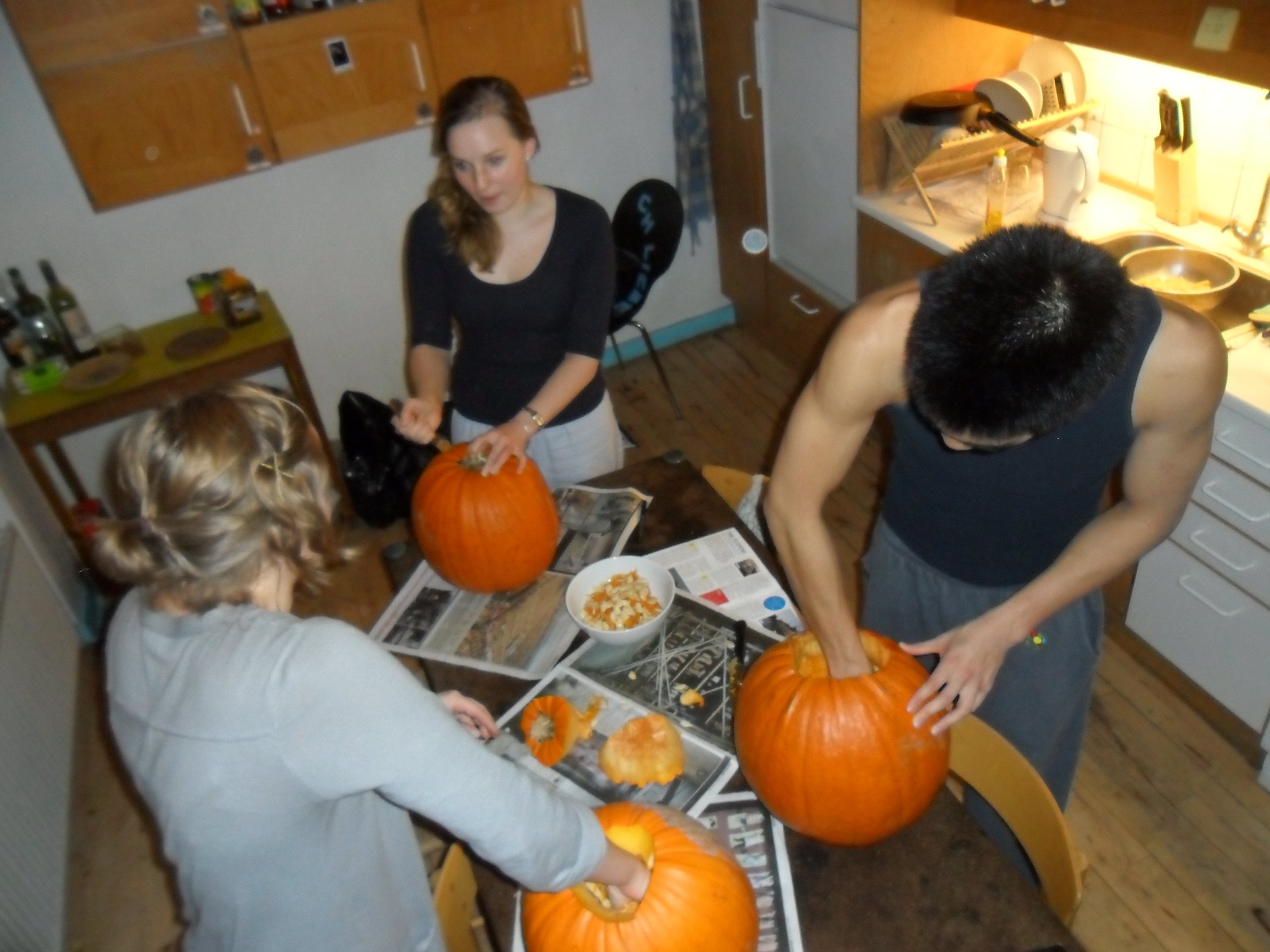 Tanya Dahl (center), an international student from Australia carves her first pumpkin in celebration of her American roommates' famous holiday, Halloween