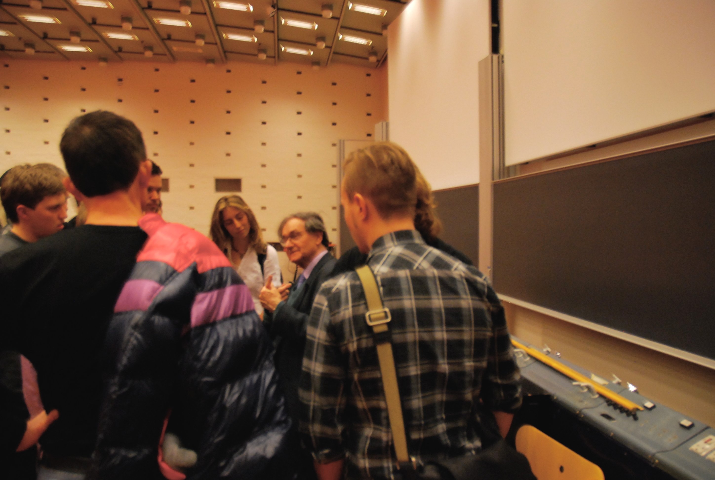 Students and autograph hunters swarmed in to get the attention of Professor Penrose (in the centre of the group with glasses)