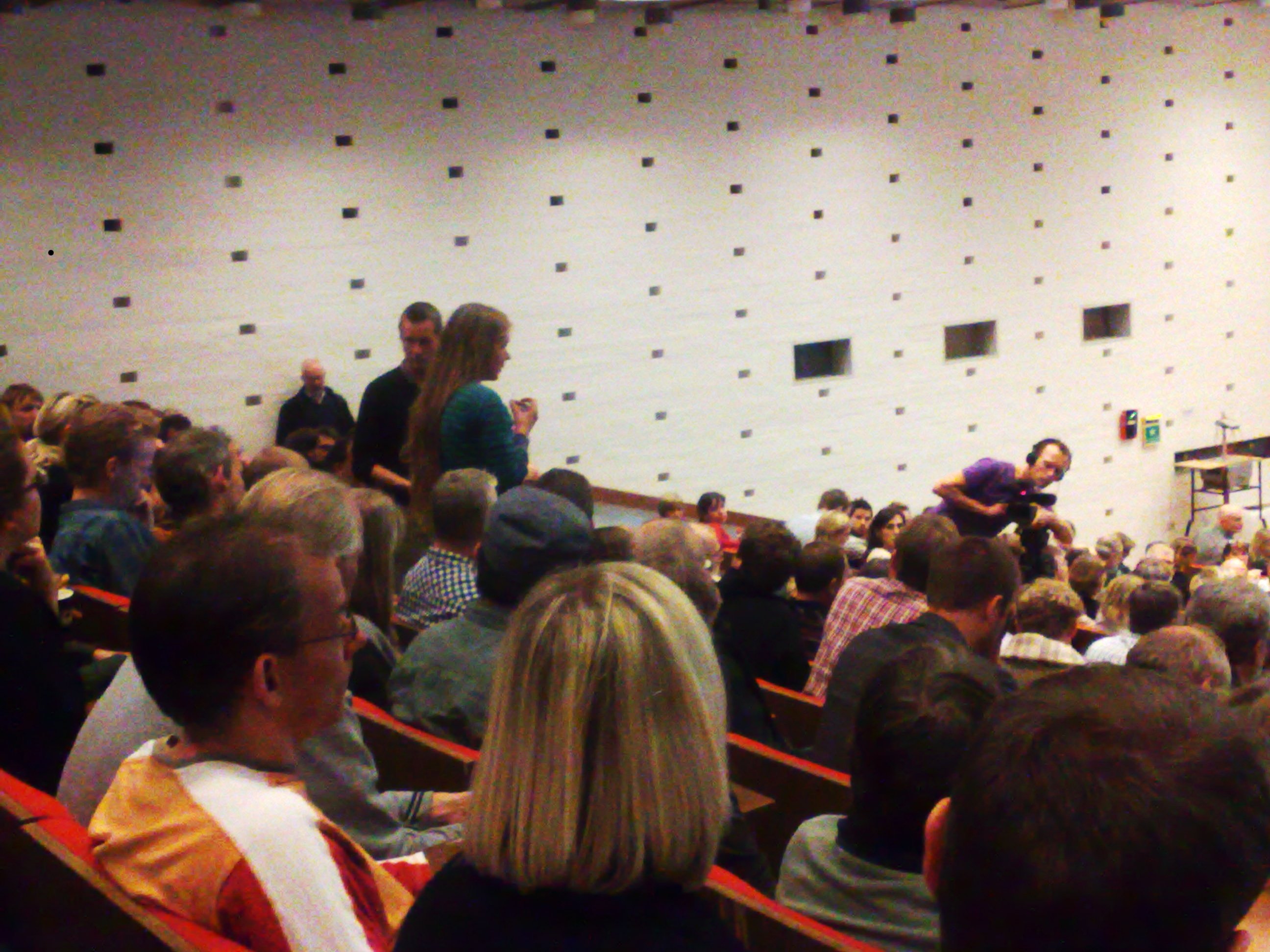 Student asks a question to top university managers after their presentation of the new faculty organisation