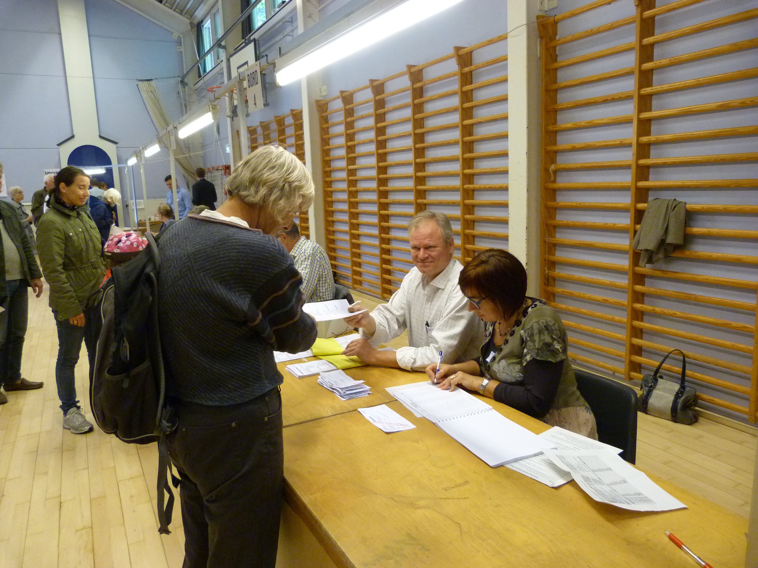 Voters receiving ballots at Øster Farimags school in Copenhagen today Thursday