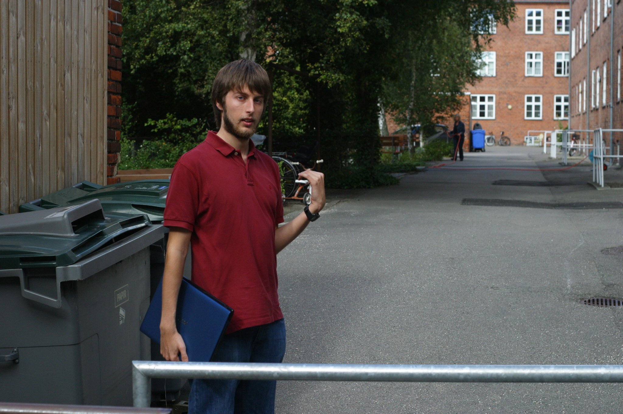 David pointing to the place where he sits outside to catch the net as he has no wireless net in the flat