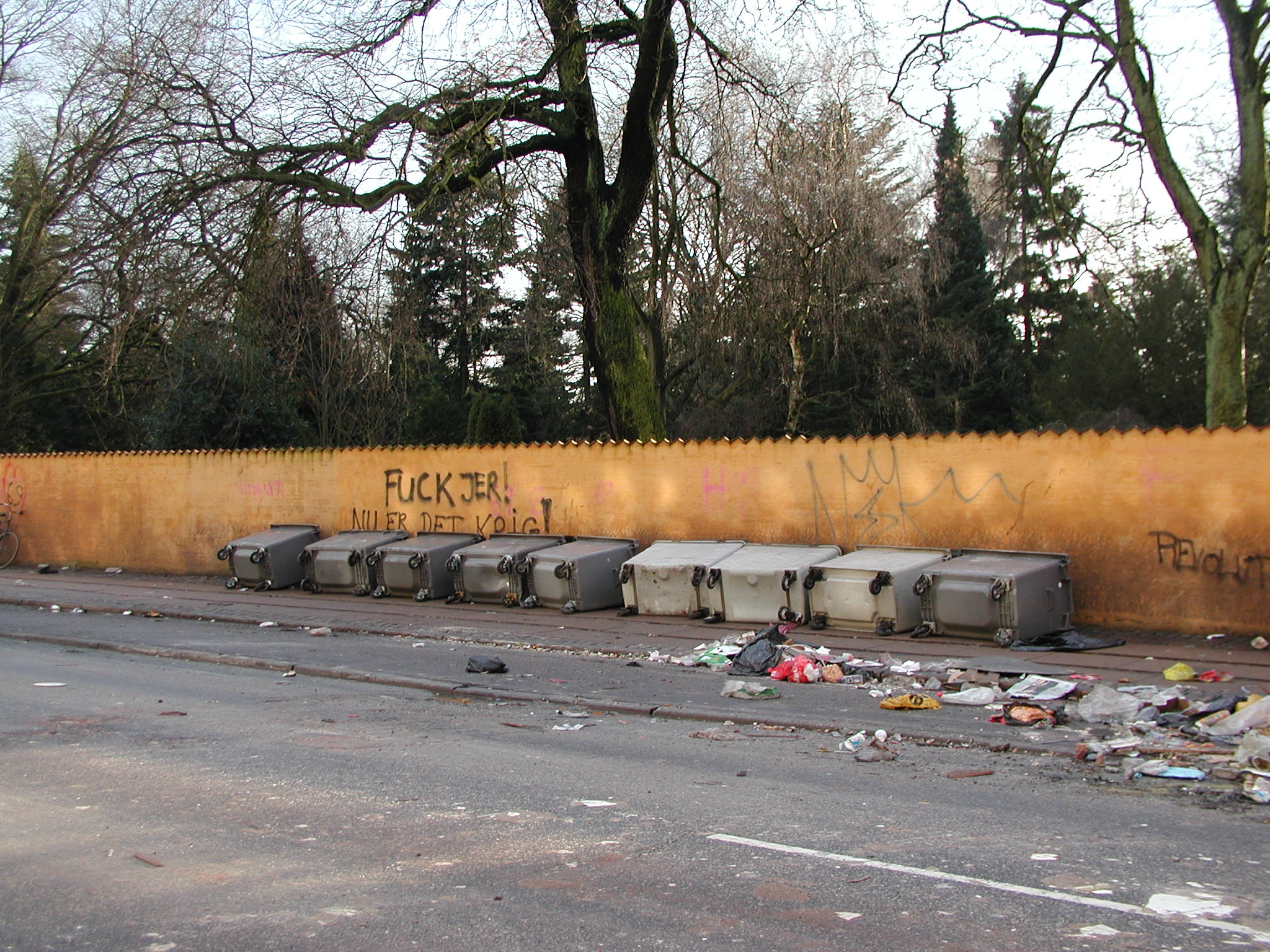OK this is after a riot in 2007, but it says it all. This is the street Nørrebrogade. Behind the wall is the Assistens churchyard