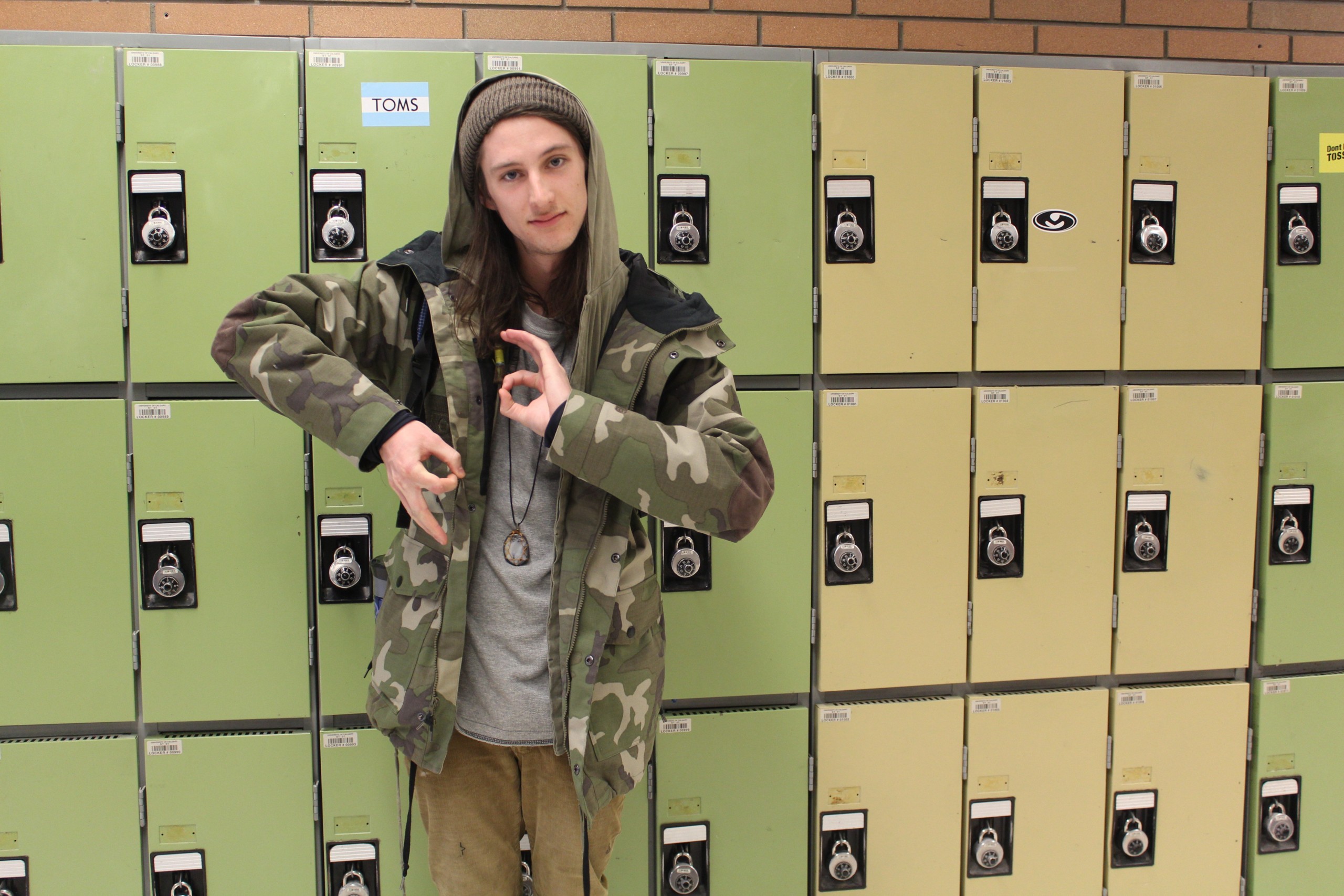 Dave plays up the green color in his outfit of choice. From head to toe, he works the camo look. He is a physics student, and says that the program is decent, but really likes that he didn't have to move away for school. 