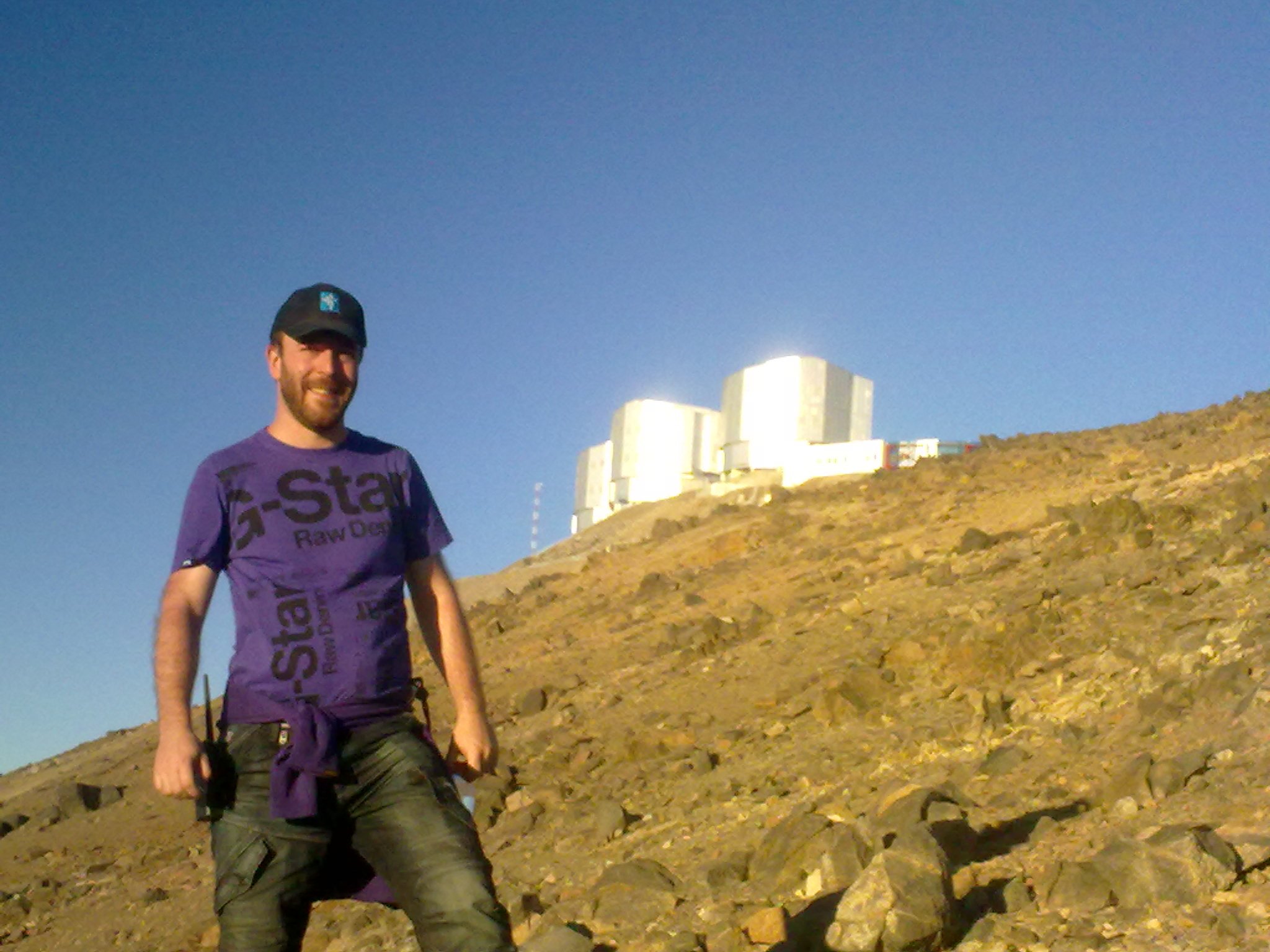 Daniele Malesani posing in front of astronomical observatory Cerro Paranal, in the Atacama desert.