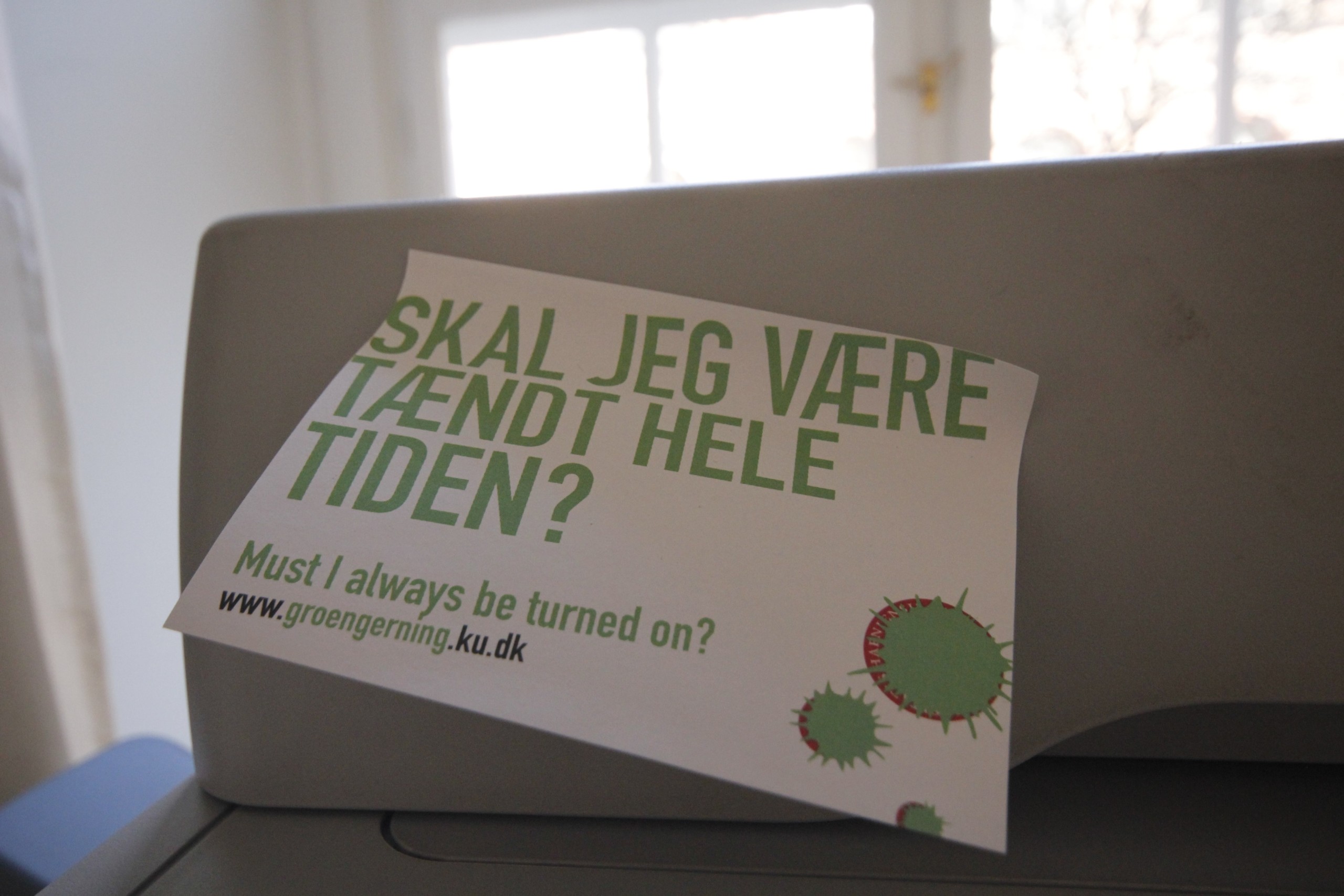 From the 2012 campaign: 'Must I always be turned on?' stickers on printers. The pun is intended. Latest survey will help Green Campus fine tune this message, it says