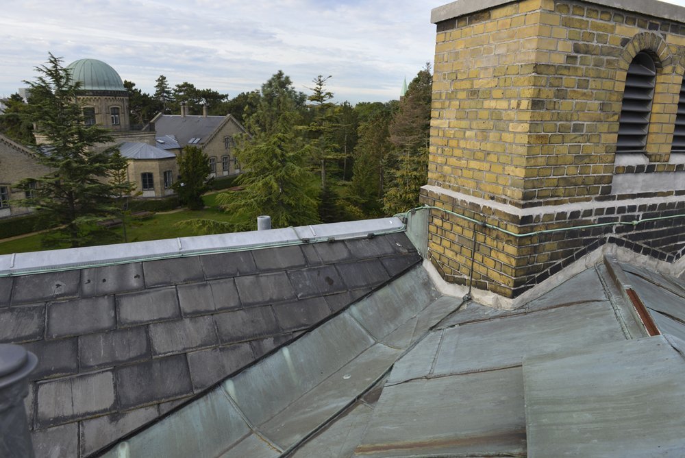 KU-BYGNINGER - Det fine (pt ved at blive reparerede) tag på Geologisk Museum med et halvt kig til det astronomiske observatorium på Østervold. KU holder til i bygninger, der er milliarder af kroner værd.