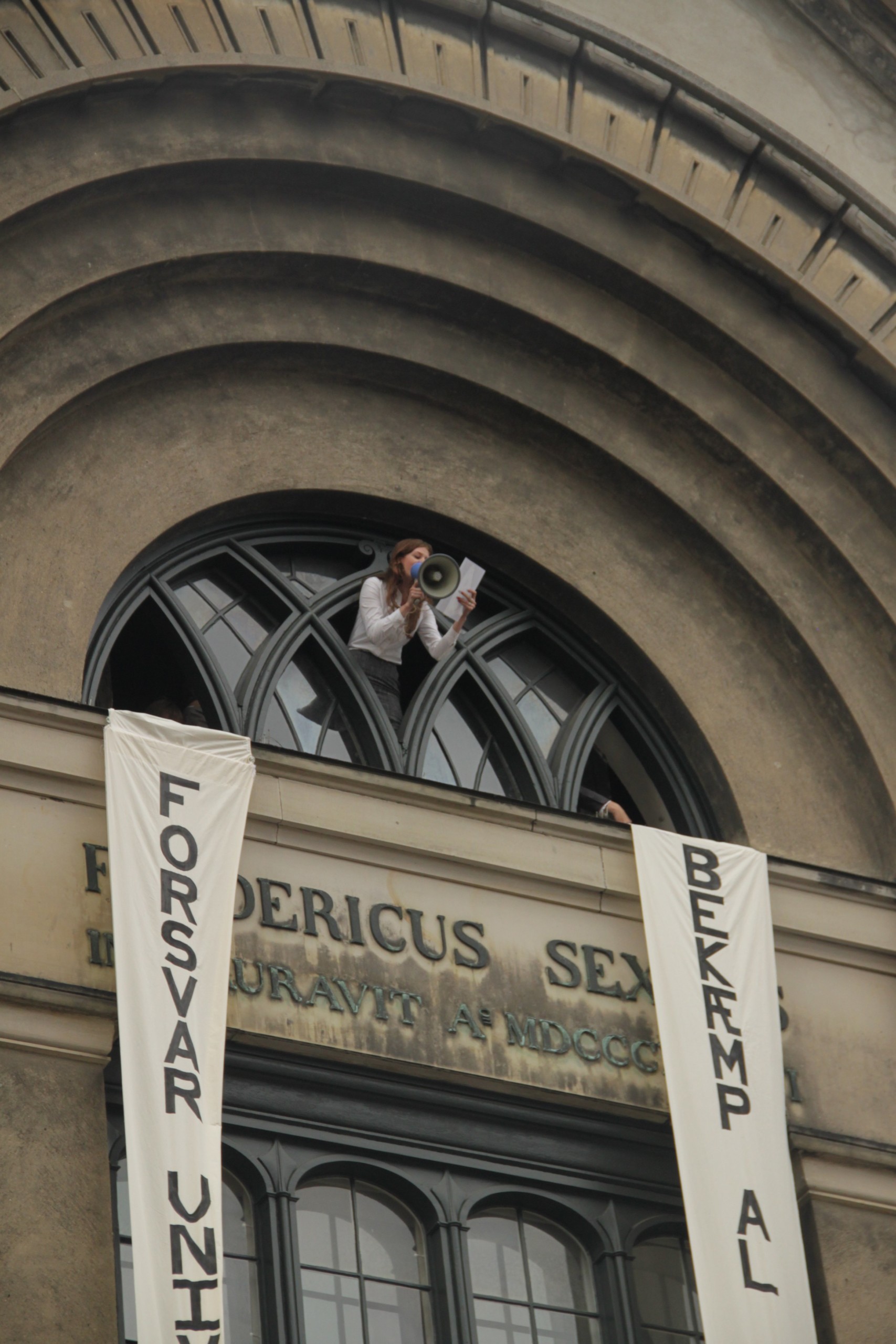 PIRATTALE - En ung kvinde repræsenterer 'Et andet universitet' fra KU's hovedbygning. Fotoet er taget af gruppen selv.