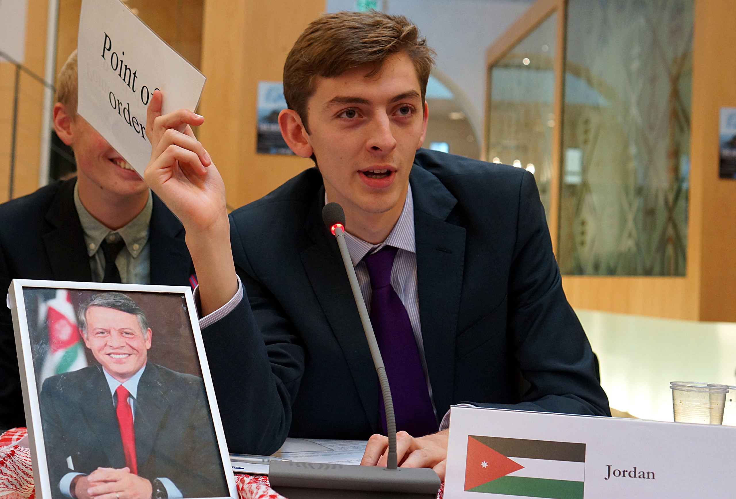 The students take a political stand accordingly to the nation they represent. Seen here is the representative from Jordan with the photo of the Jordanian king