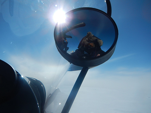 The author Nanna took a 'selfie' using the side mirror of a ski-doo snowmobile when she went out to measure radar and GPS points 7.5 km from camp