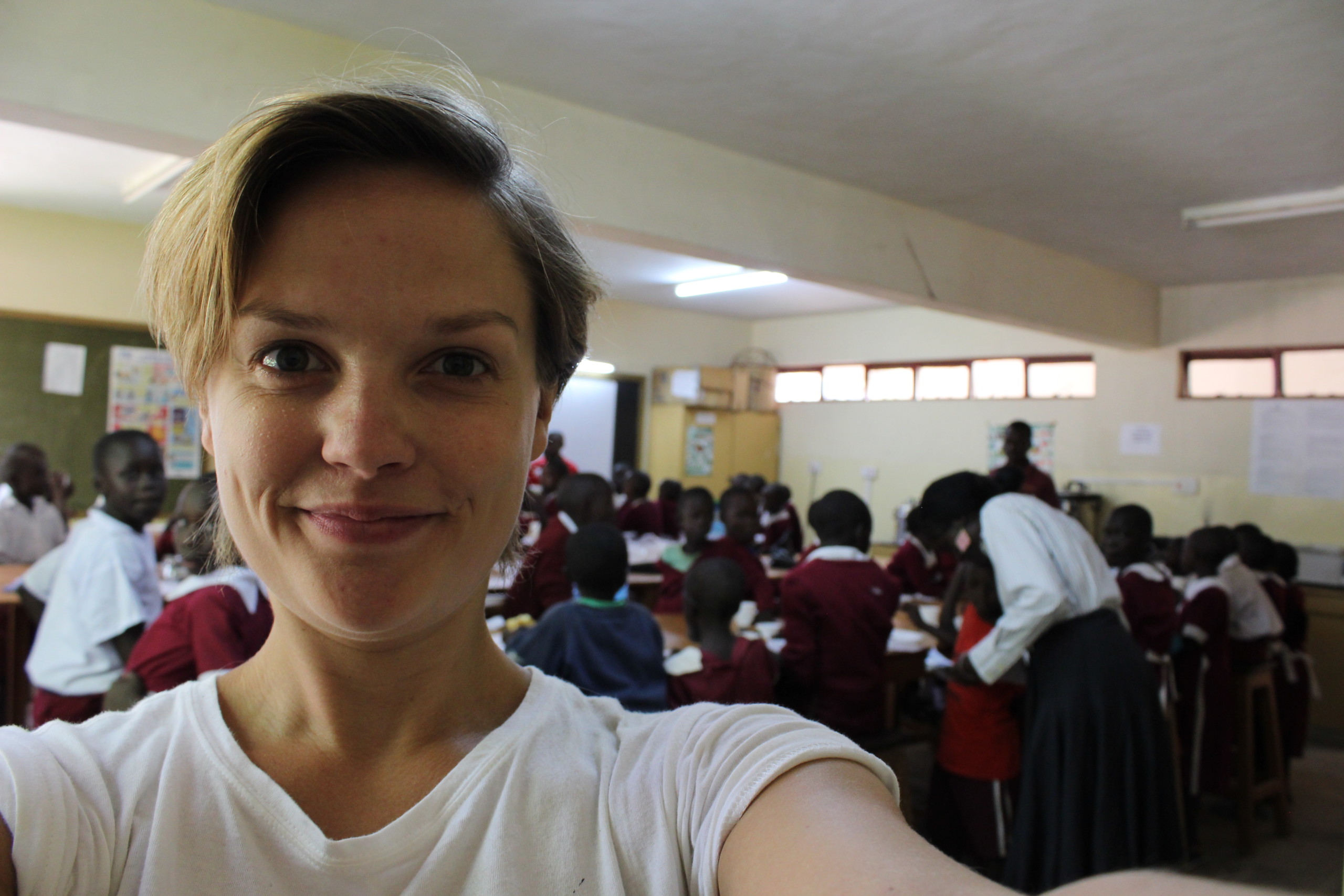 Selfie with children eating biscuits in the background. Image: Anja Maria Homann
