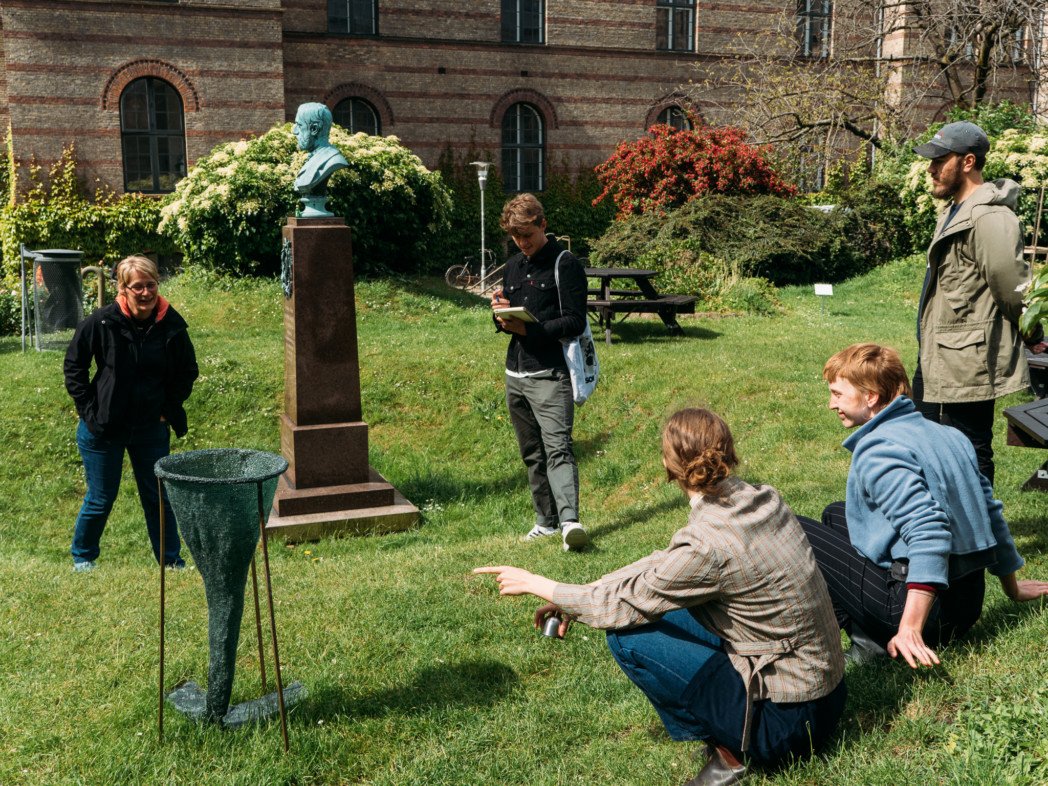 Heidi (left) who is employed at South Campus, views the exhibited art in the courtyard at CSS. To the right, the artists follow her experience.