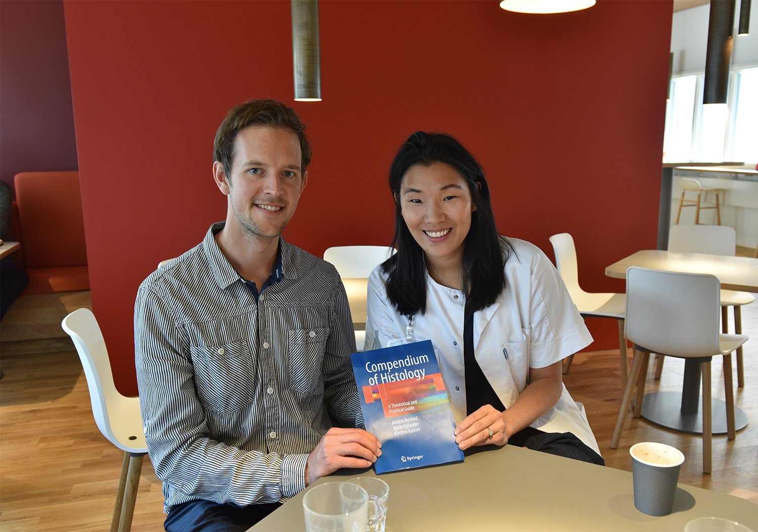 Anders Rehfeld og Kirstine Karnov i Mærsk Tårnet med forsiden til den bog, de har skrevet sammen med Malin Nylander. (Bogen på billedet er en dummy, den rigtige bog var ikke ude af trykken, da vi mødte dem).