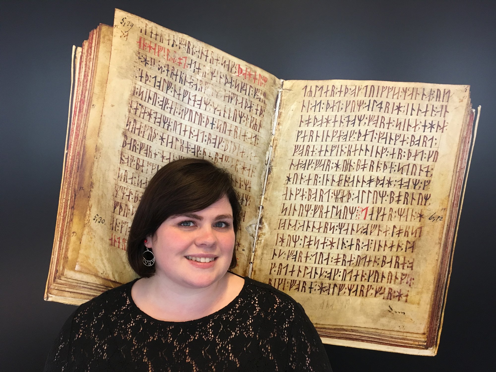 Katrín Þórdís Driscoll heads the team of student assistants that are digitizing the Department of Nordic Studies and Linguistics’ collections. Here she is photographed in front of a picture of the Codex Runicus manuscript.