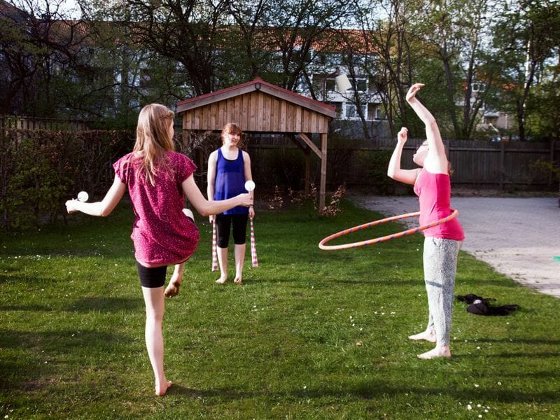 Some residents practicing their circus skills in the garden.
