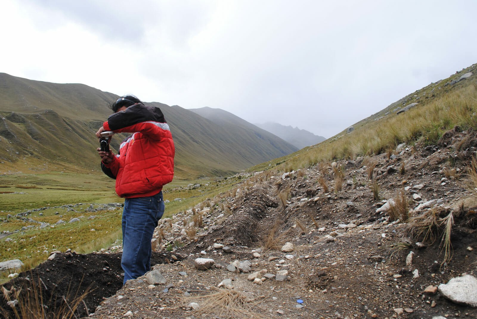 A community member inspects the construction of a new irrigation canal.