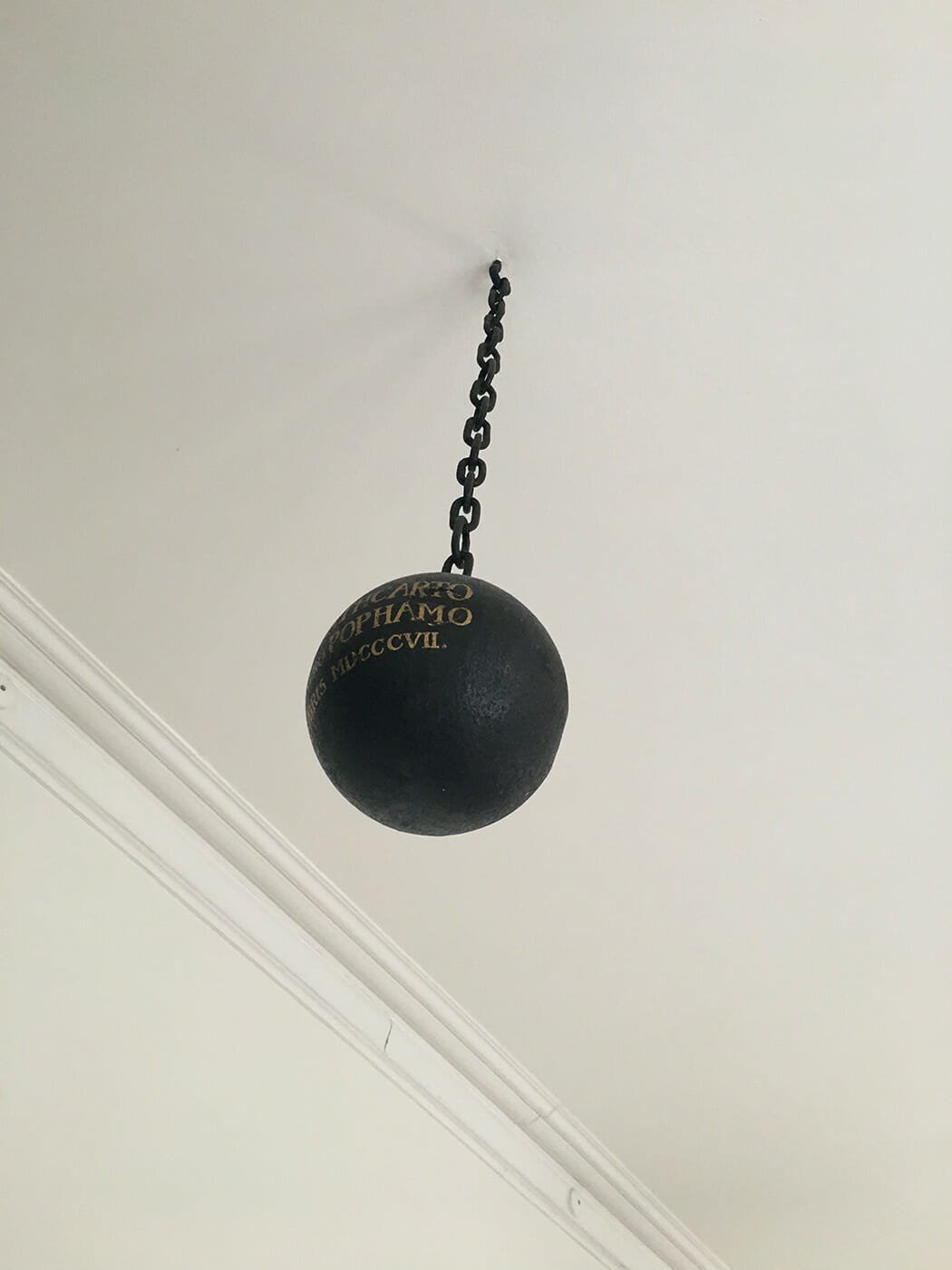 1807 cannonball hanging suspended from the ceiling right outside the door of the Rector's Office in Nørregade in the old part of The University of Copenhagen. 