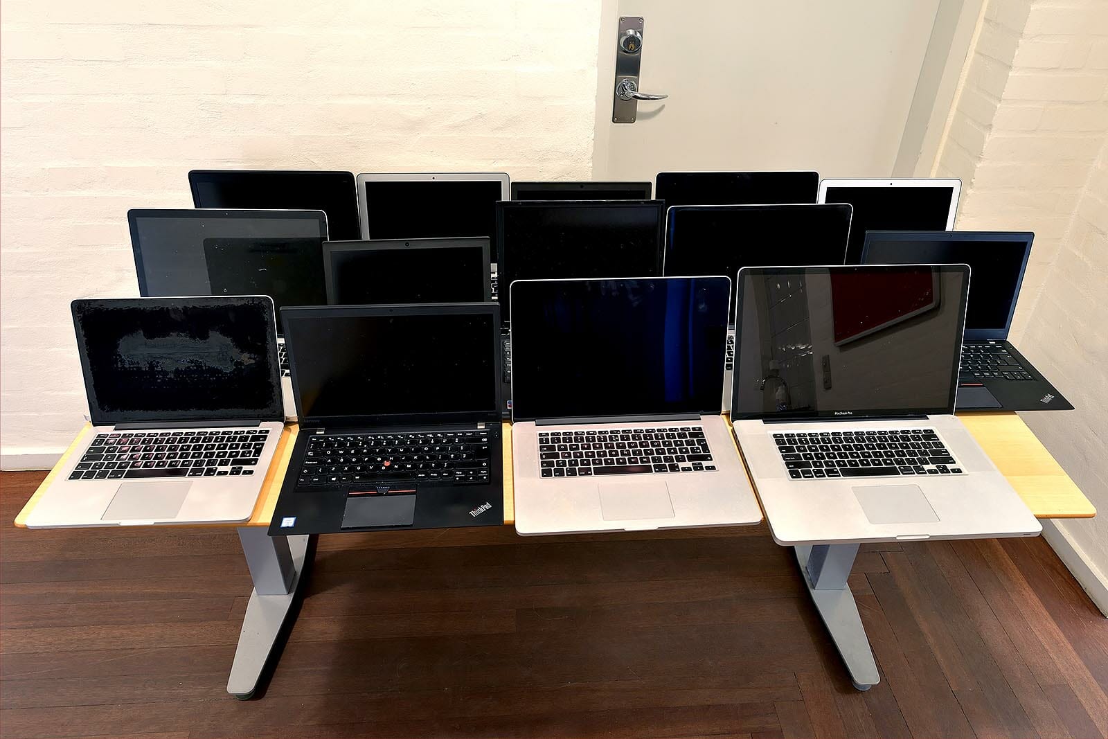 Her er de cirka 15 bærbare computere, som Morten Petersson arbejder med for tiden - nogle til genbrug andre til skrotning - stillet op på et bord. Nogle af computerne på billedet er store, bærbare Apple-computere, der ifølge Morten Petersson kun er få år gamle og kan have kostet op til 18.000 kroner som nye. 