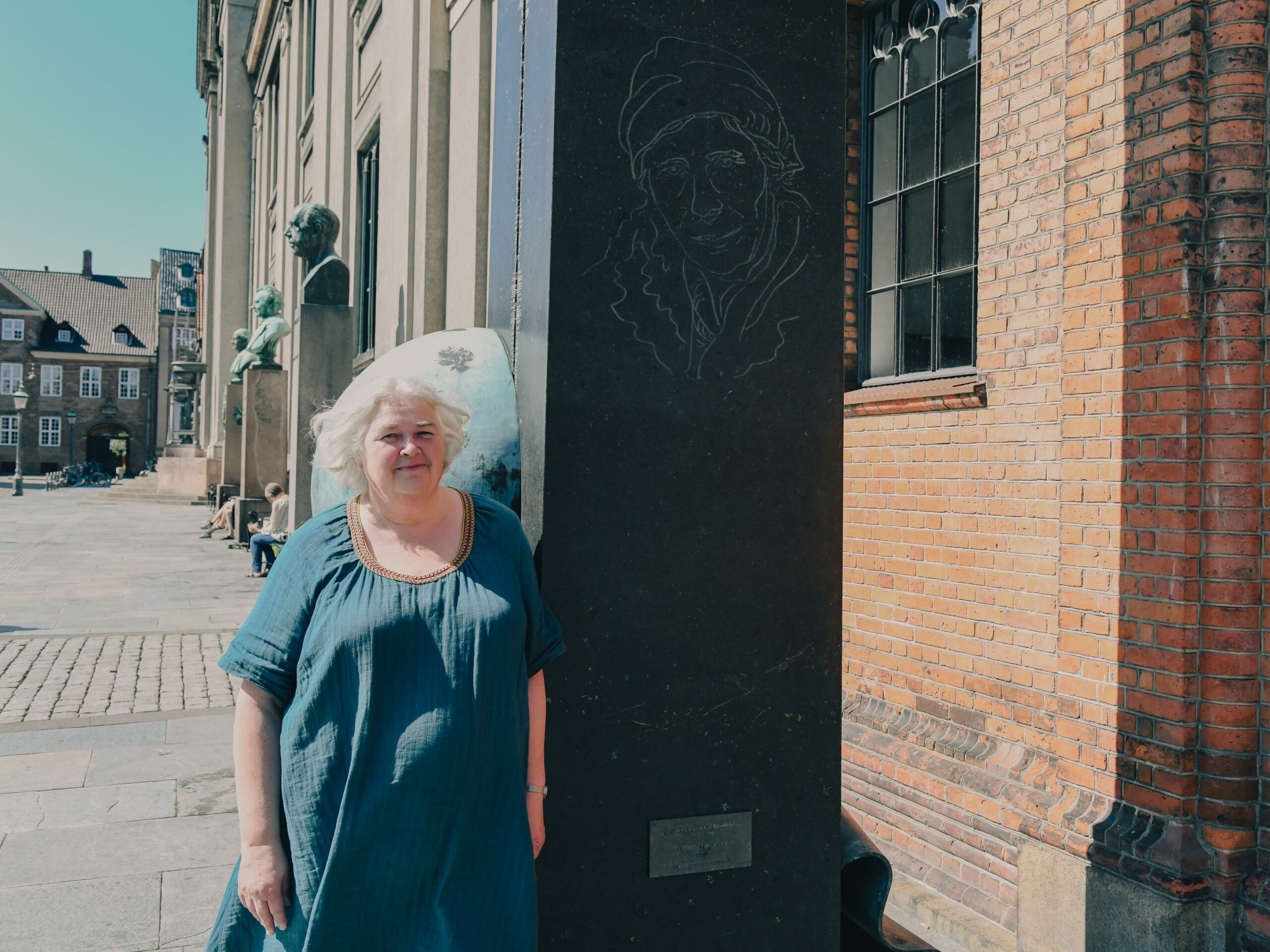 Trine Dahl-Jensen in front of the memorial to Danish geophysicist Inge Lehmann at Frue Plads