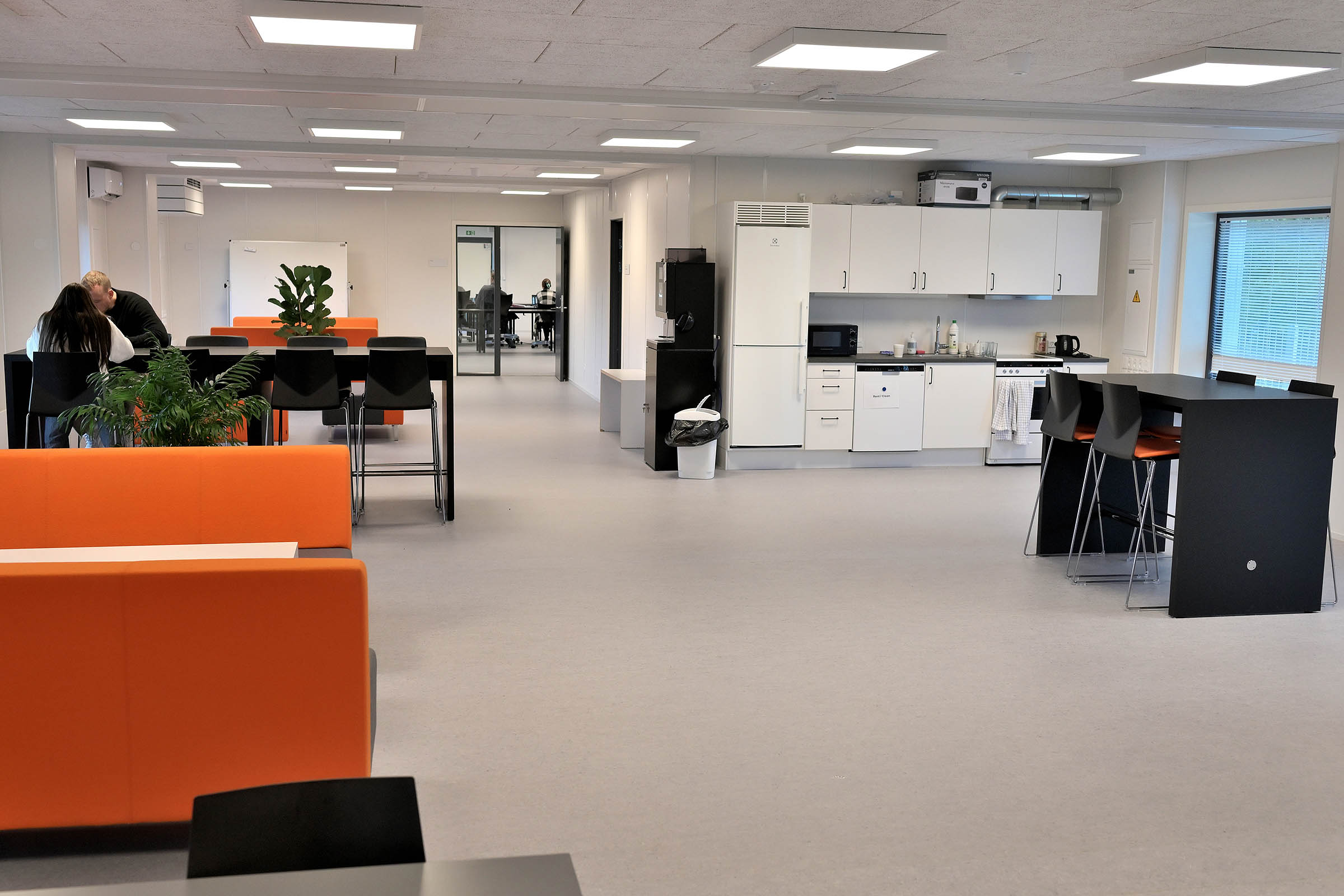 Large living room and kitchen indoors. The classrooms are at both ends of the building.
